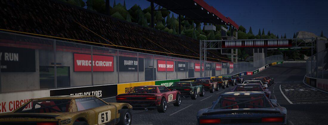 The Quarry Run starting grid beside the pit wall, with trees above the grandstand